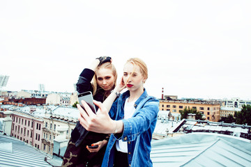 two cool blond real girls friends making selfie on roof top, lifestyle people concept, modern teens