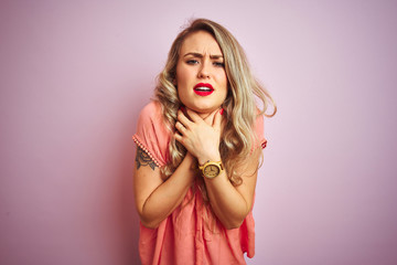 Wall Mural - Young beautiful woman wearing t-shirt standing over pink isolated background shouting suffocate because painful strangle. Health problem. Asphyxiate and suicide concept.