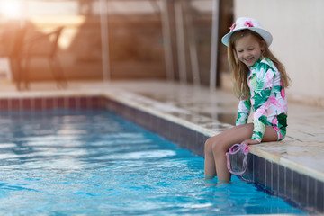 Kid girl with sun protection cream on her skin spends time in the pool. Children, summer, holiday and healthcare concept