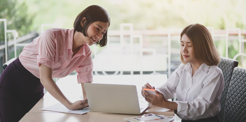 Canvas Print - two young professional ui graphic designers discussing on their smartphones templates