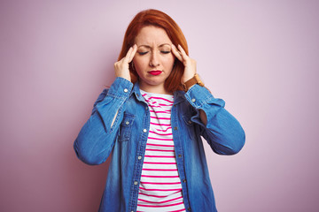 Poster - Beautiful redhead woman wearing denim shirt and striped t-shirt over isolated pink background with hand on headache because stress. Suffering migraine.