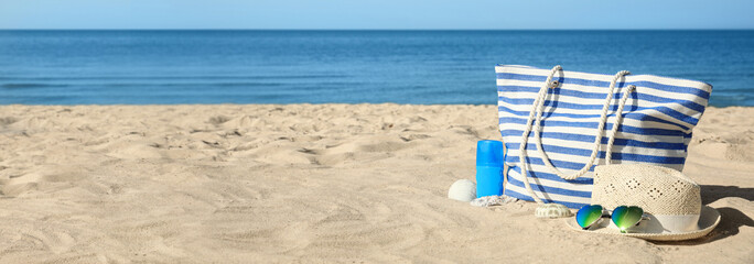 Poster - Stylish beach accessories on sandy sea shore