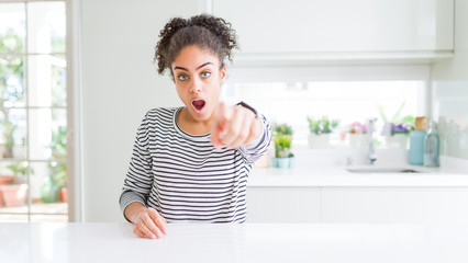 Poster - Beautiful african american woman with afro hair wearing casual striped sweater pointing displeased and frustrated to the camera, angry and furious with you