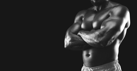 Wall Mural - Black and white image of muscular african athlete body