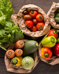 Wall Mural - Close up of fresh eco vegetables in coton bags on wood