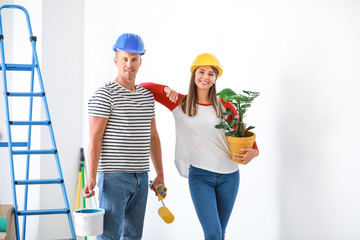 Wall Mural - Happy young couple doing repair in their new house