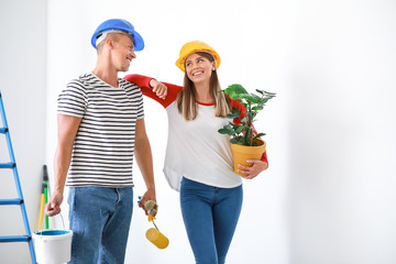 Wall Mural - Happy young couple doing repair in their new house