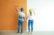 © Pixel-Shot - Happy young couple painting wall in their new house