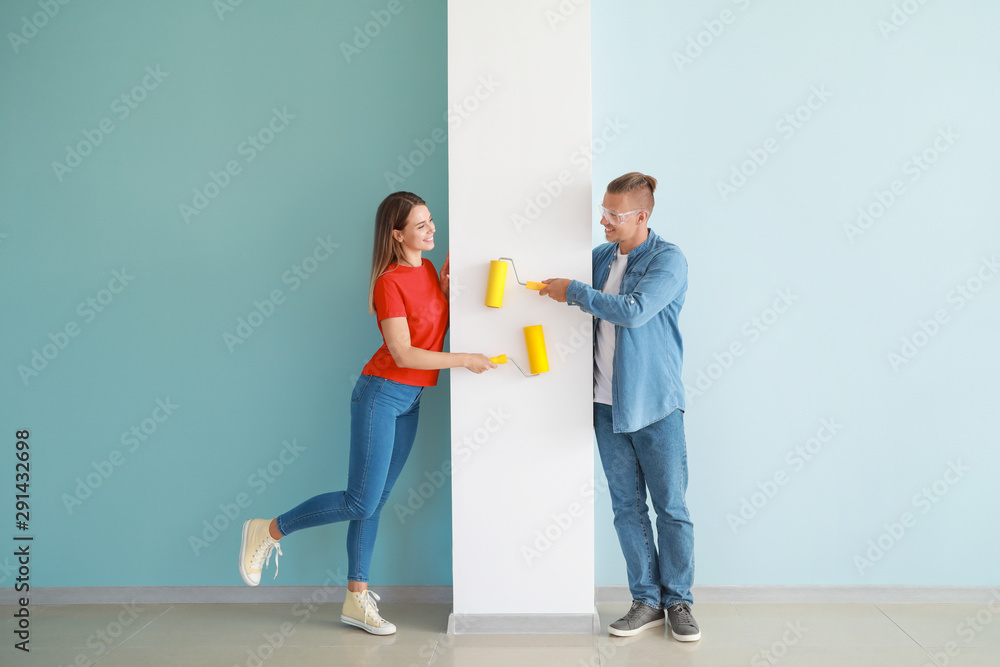 Happy young couple doing repair in their new house