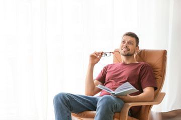 Wall Mural - Man with book relaxing at home