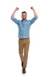 © Viorel Sima - casual man walking with hands up in the air victorious
