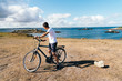 © jjfarq - Attractive young male riding bicycle in the Island of Batz
