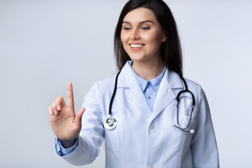 Wall Mural - Lady Doctor Using Invisible Touchscreen Pressing Key In Studio