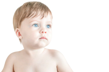 Sad blue-eyed blond kid on a white background. Isolated.