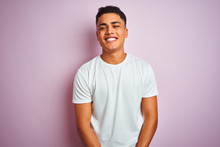 Young Brazilian Man Wearing T-shirt Standing Over Isolated Pink Background With A Happy And Cool Smile On Face. Lucky Person.