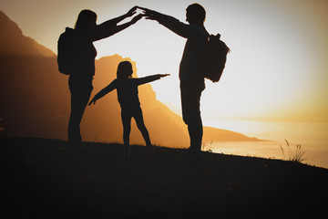 Poster - happy family- mom, dad and little girl- travel in mountains at sunset