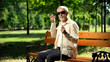 © motortion - Visually impaired old man using voice control app in smartphone, innovations