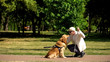 © motortion - Blind male stroking guide dog in park, best friend of people, guidance concept