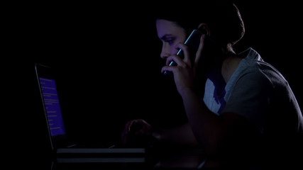 Woman watching at blue screen of death on her laptop and calling to master