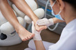 Pedicurist gently massaging woman leg after pedicure
