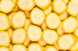 © Nikolay - Fresh banana slices background. Top view.
