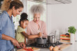 © ReeldealHD images - Three generations of family cooking a meal together