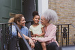© ReeldealHD images - Three generations of women sitting outside family home