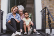 © ReeldealHD images - Three generations of women sitting outside family home