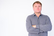 © Ranta Images - Portrait of overweight businessman with arms crossed