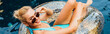 © LIGHTFIELD STUDIOS - panoramic shot of smiling sexy young woman in swimsuit and sunglasses lying on swim ring in pool