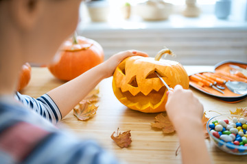 Poster - Woman is carving pumpkin