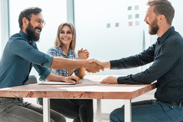 Canvas Print - smiling businesswoman shaking hands with her business partner