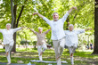 © Yakobchuk Olena - Cheerful senior people practicing qigong in the park
