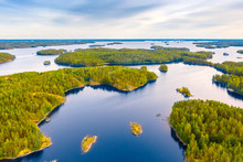 Aerial View Of Of Small Islands On A Blue Lake Saimaa. Landscape With Drone. Blue Lakes, Islands And Green Forests From Above On A Cloudy Summer Morning. Lake Landscape In Finland.