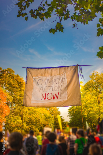 Banner Demanding Climate Action Now at March for Climate in Glasgow Scotland With Protesters and Autumn Leaves in the Background