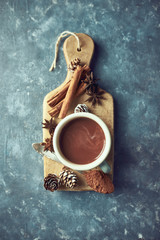 Sticker - Hot chocolate with winter spices on  wooden kitchen board. Flat lay. Still life