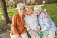 Joyful Old Women Sitting On Bench In The Park