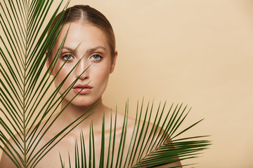 Poster - Blonde woman posing naked with green nature leaf plant.