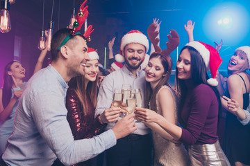 Poster - Portrait of nice attractive stylish cheerful cheery positive excited glad ladies and guys having fun rest relax tradition winter vacation feast festive at modern luxury fogged lights nightclub