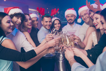 Poster - Portrait of nice-looking attractive glamorous stylish cheerful cheery positive girls and guys having fun clinking wineglass December winter tradition in luxury place nightclub lights indoors