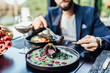 © Тарас Нагирняк - Close up photo, man ready to eat medium rare beef steak while sitting in modern restaurant, healthy food.