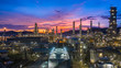 Oil​ refinery​ with oil storage tank and petrochemical​ plant industrial background at twilight, Aerial view oil and gas refinery at twilight.