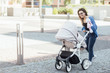 © Тарас Нагирняк - Mother walking with hewborn baby in stroller, woman holding soft toy and spend time funny.