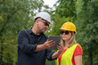 © cineberg - Architect and builder or surveyors discussing about the building location for an ecological forest project