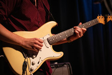 Male Guitarist Playing An Electric Stratocaster Guitar On A Gig