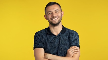 Wall Mural - Happy handsome man smiling with crossed arms