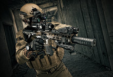 Special Forces Operator In Full Gear With Rifle, Aiming At The Enemy.