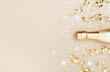 © juliasudnitskaya - Golden champagne bottle with confetti stars and party streamers top view. Christmas, birthday or wedding background. Flat lay style.