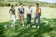 © rh2010 - Young and elegant friends standing together with golf equipment during a golf play on the beautiful course on a sunny day