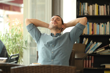 Relaxed adult man resting in a coffee shop